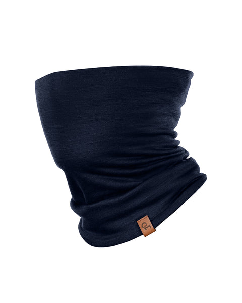 A dark navy blue tubular neck gaiter displayed against a solid white background. The soft fabric is styled with natural-looking folds and slouching, and a small, rectangular brown leather logo tag is attached near the bottom edge.