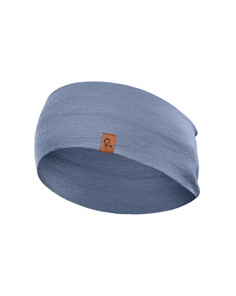 A light dusty blue, finely knitted headband displayed in a three-dimensional, rounded shape against a pure white background. A small, square brown leather logo patch is centered near the bottom front edge.
