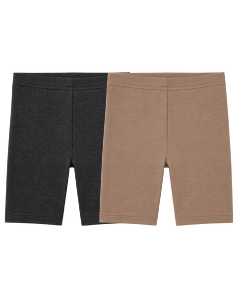 Two pairs of plain kids' cycling shorts laid flat side by side against a white background. The pair on the left is dark grey, and the pair on the right is light brown.