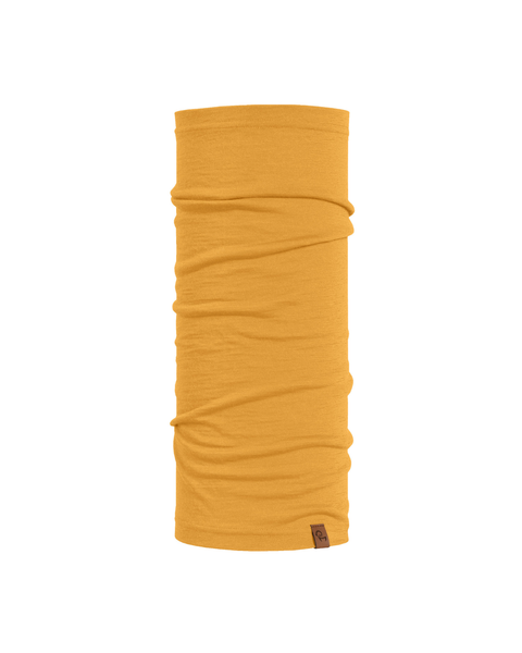 A product image of a long, tubular mustard yellow neck gaiter displayed vertically against a plain white background. The soft fabric features natural horizontal folds and a small brown logo tag attached to the bottom right edge.