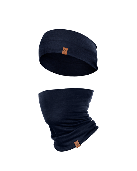 A product shot featuring a matching set of a dark navy blue headband and a tubular neck gaiter floating against a pure white background. The headband is positioned slightly above the gaiter, which shows natural draping. Both items feature a small, square brown leather logo patch on the edge facing forward.