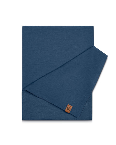 Merino Wool denim scarf with a brown label on a white background