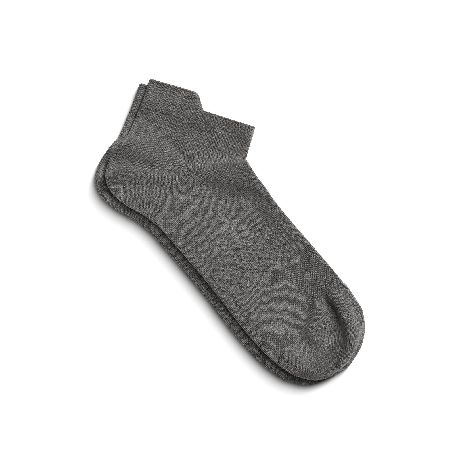 A single gray ankle sock shown on a foot model, angled to display the side profile and the top opening.
