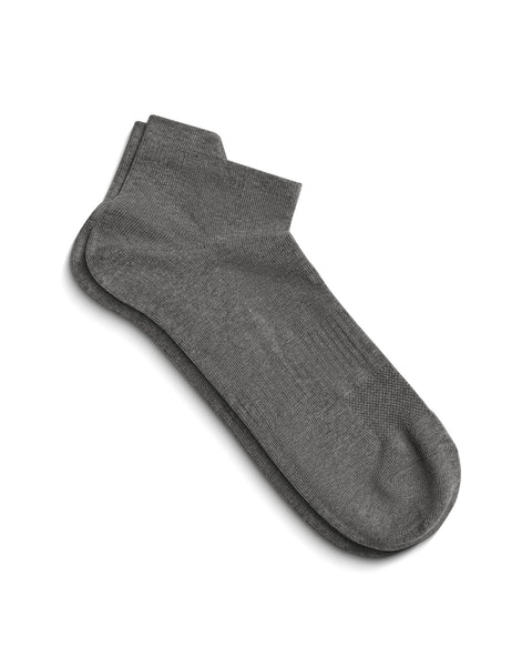 A pair of gray ankle socks lying flat on a white surface, showing the top of the foot and the ankle opening.