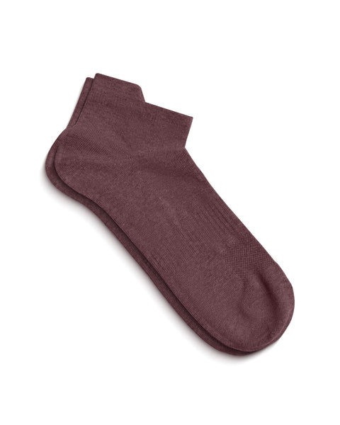 A pair of dark pink ankle socks lying flat on a white surface, slightly overlapping to show the top of the foot and the ankle opening.