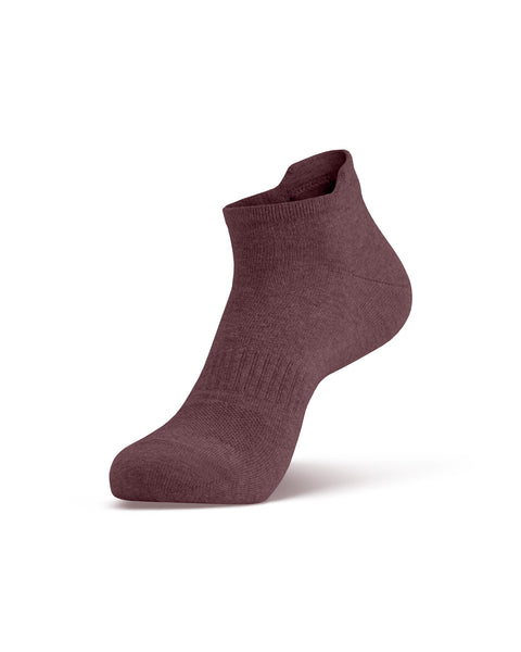 A single dark pink ankle sock shown on a foot model, angled to display the side profile and the top opening.