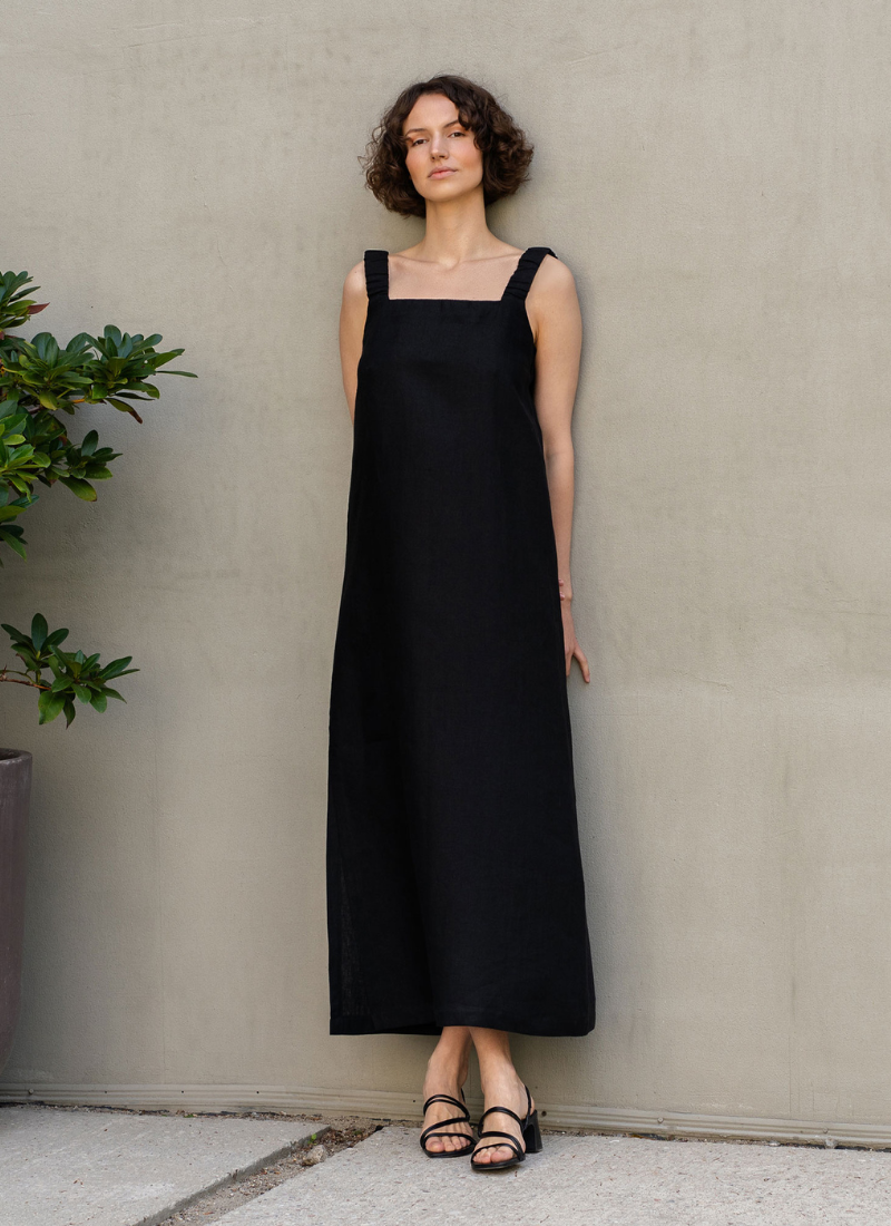 Woman wearing black linen sleeveless dress, minimalist natural style outfit