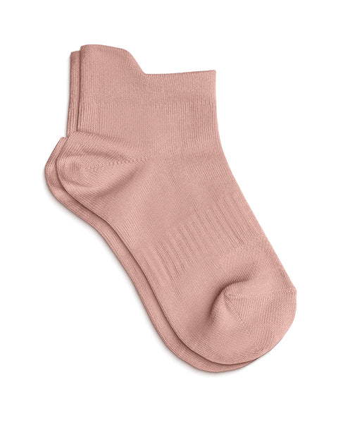 A pair of light pink ankle socks laid flat on a white background, with one sock resting slightly on top of the other.