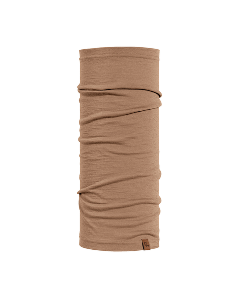 A product shot of a light beige tubular neck gaiter displayed upright against a pure white background. The fabric shows natural horizontal folds, and a small, square brown leather logo patch is visible near the bottom right edge.