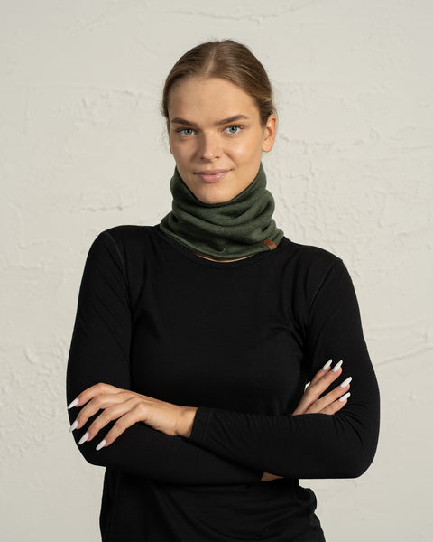 Woman in dark green Merino wool knit neck warmer, soft winter accessory for cold weather.
