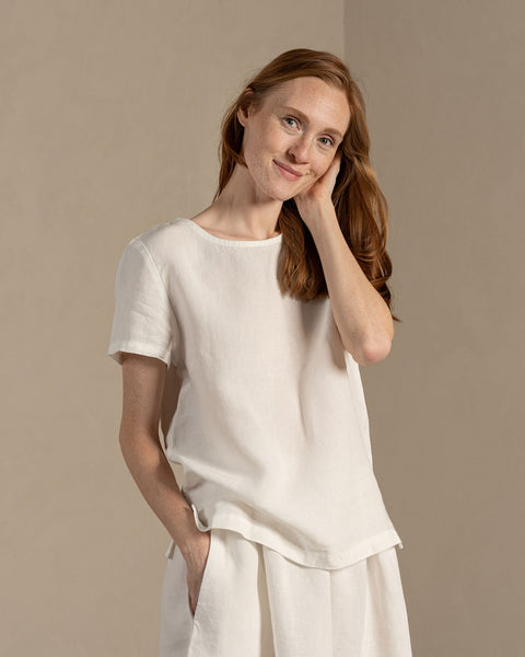 Woman wearing Linen short sleeve top Emma in Pure WHite color matched with Linen skirt Sophia