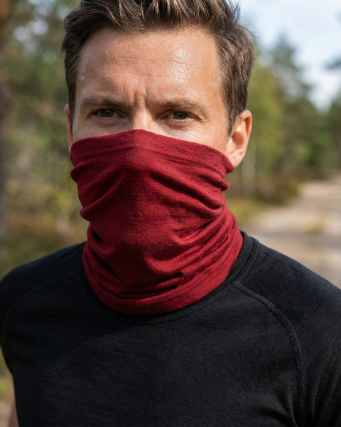 Man wearing royal cherry merino wool long neck gaiter outdoors, breathable temperature-regulating face and neck protection for hiking and active use