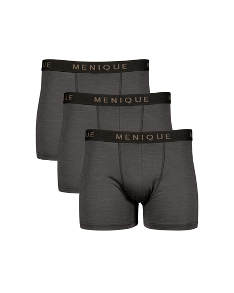 A flat-lay product shot of three identical pairs of men's short boxer briefs in a charcoal grey color. They are arranged in a staggered vertical stack. Each pair features a contrasting black elastic waistband with "MENIQUE" woven in light brown text. The background is pure white.