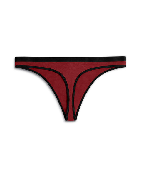 Back view of a women's merino wool thong in Royal Cherry (deep red), showing the thong back construction and black elastic waistband.