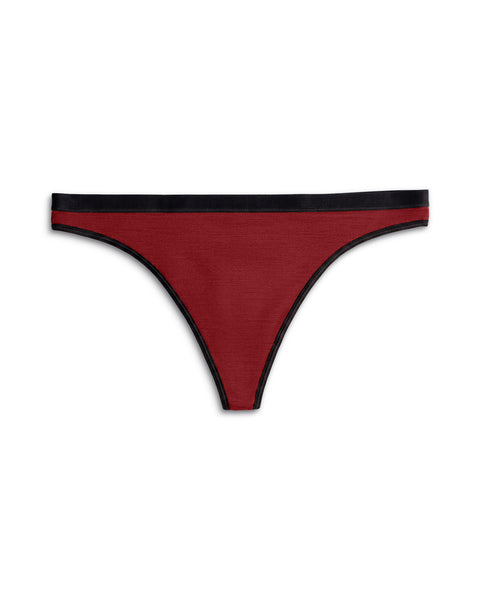 Front view of a women's merino wool thong in Royal Cherry (deep red) with a contrasting black elastic waistband and black trim.