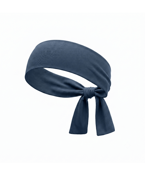 A product shot of a solid denim-blue fabric headband, curved as if worn, and tied in a knot at the bottom against a plain white background.