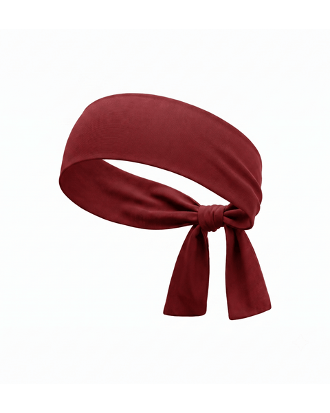 A product shot of a solid deep red (royal cherry) fabric headband, curved to show its shape, and tied in a knot at the bottom against a plain white background.