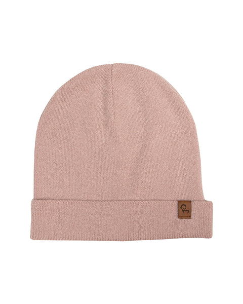 A dusty pink knit beanie hat laid flat against a pure white background. The beanie features a folded ribbed brim with a small, square brown leather logo patch sewn onto the right side.