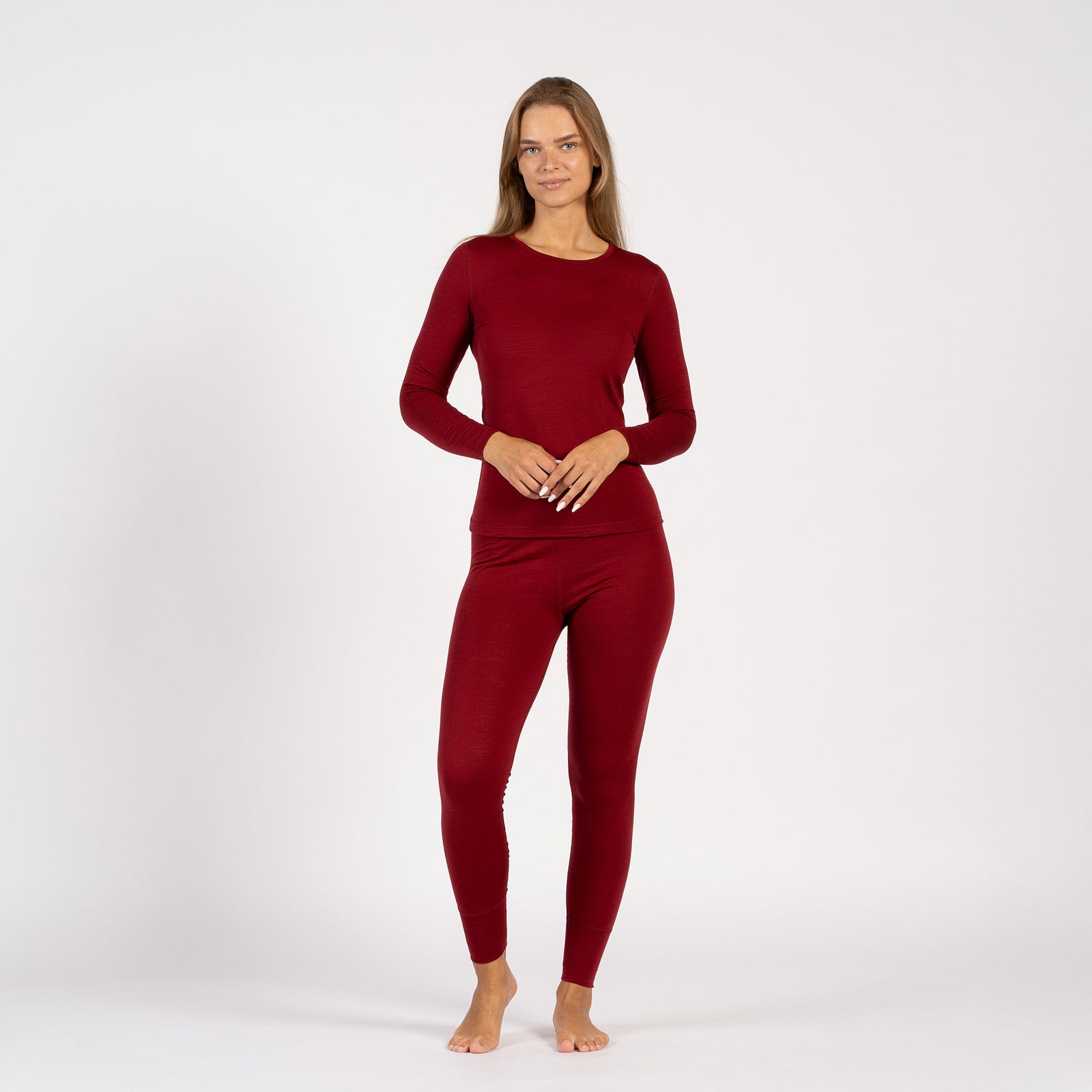 Side detail of royal cherry Merino wool thermal leggings, high-waist fit.
