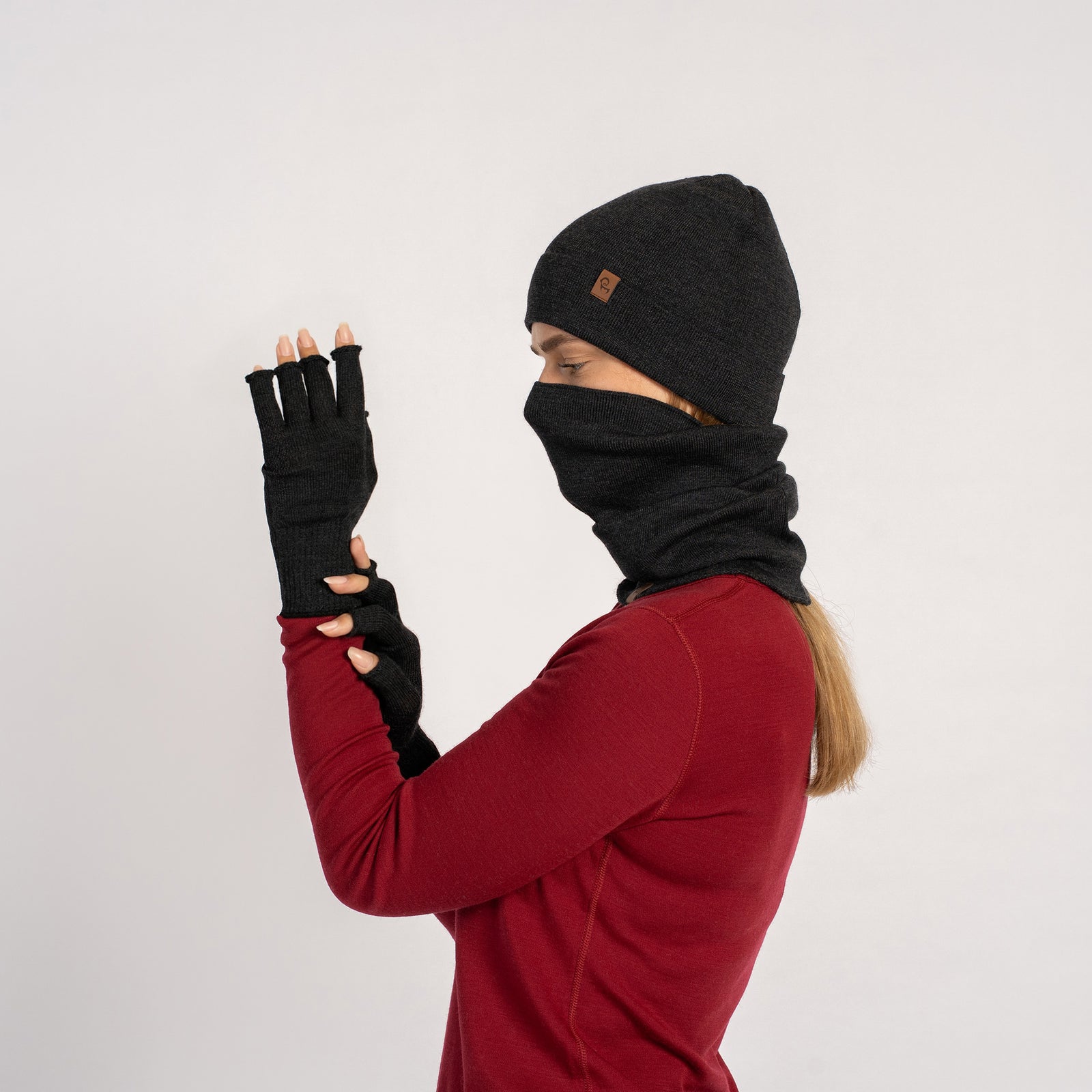 Dark Green menique knit beanie, neck gaiter, and fingerless gloves set on a white background